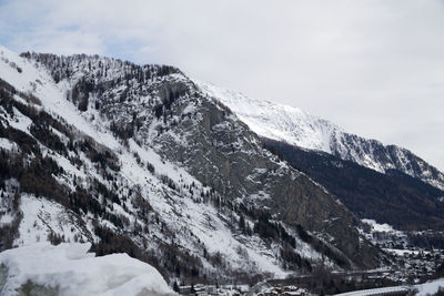 Low angle view of snowcapped mountain against sky