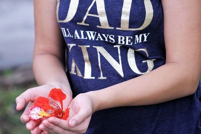 Low section of person holding white rose