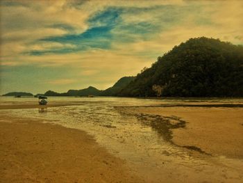 Scenic view of beach against sky during sunset