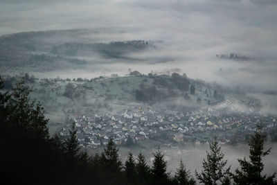 The village of michelbach in the northern black forest is shrouded in fog on a winter's morning