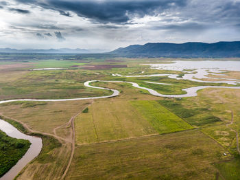 Scenic view of agricultural field against sky