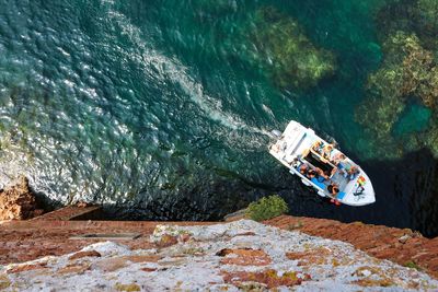 People sitting on boat in sea