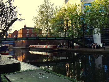 Road by river in city against sky