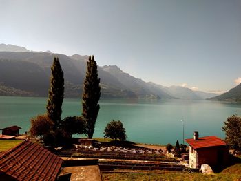 Scenic view of lake and mountains against clear sky