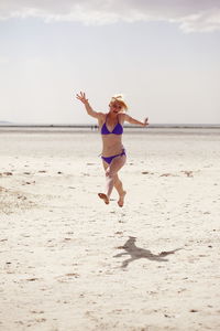 Young woman jumping in beach