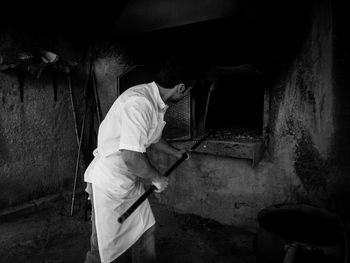 Side view of man working at bakery