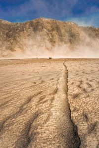 Scenic view of arid landscape against sky