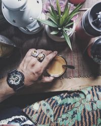 Man holding coffee cup on table