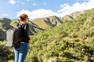 Rear view of man standing on mountain