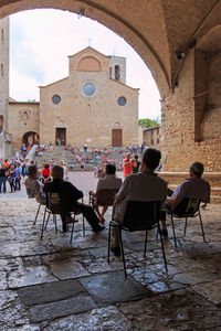 Tourists sitting on table in front of restaurant