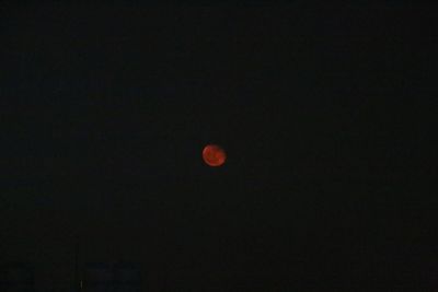 Low angle view of moon against sky at night