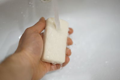 Close-up of hand holding ice cream cone