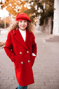 Young woman standing on footpath