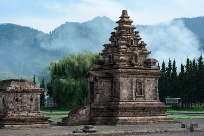 View of temple building against cloudy sky