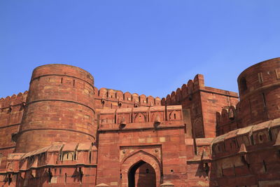 Low angle view of historical building against clear blue sky