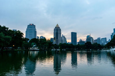 River by buildings against sky in city