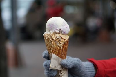 Close-up of hand holding ice cream cone