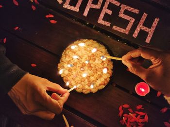 High angle view of hand holding cake