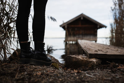 Low section of man standing on wood