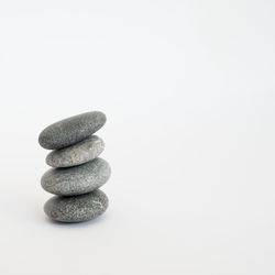 Stack of stones against white background