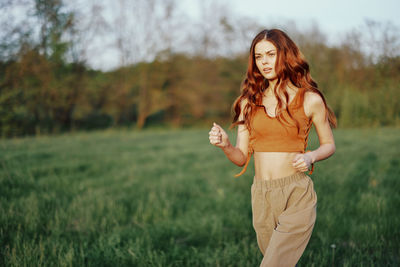 Young woman standing on field