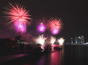 Low angle view of firework display at night