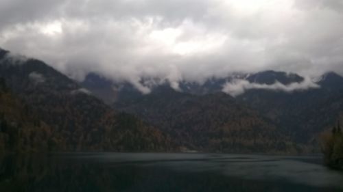 Scenic view of mountains against cloudy sky