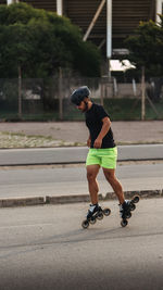 Full length of man inline skating on road