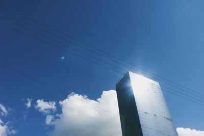 Low angle view of power lines against blue sky