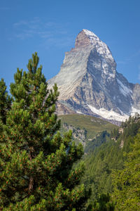 Scenic view of mountains against blue sky