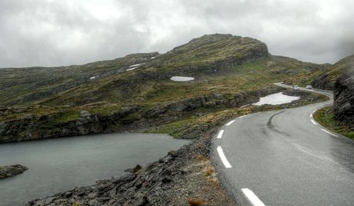 Empty road along countryside landscape