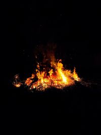 Illuminated bonfire against sky at night