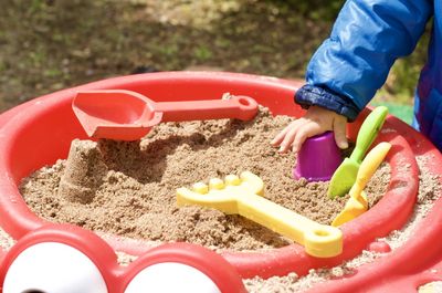 High angle view of child playing with toy on sand