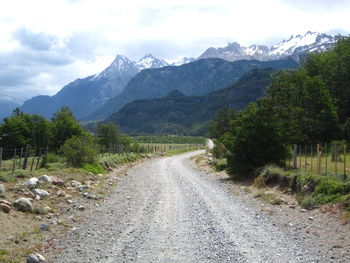 Empty road leading towards mountains