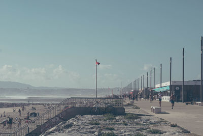 Street light on beach against sky