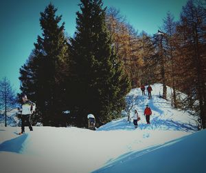 People standing on snow covered landscape