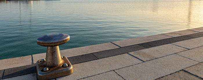 High angle view of rusty metal on pier by sea