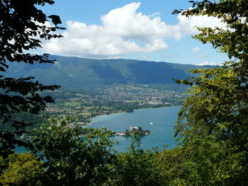 Scenic view of mountains and lake annecy seen through trees