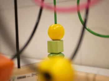 Close-up of yellow toy on wall