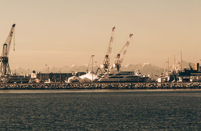 Commercial dock by sea against sky