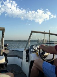 Man and boat in sea against sky