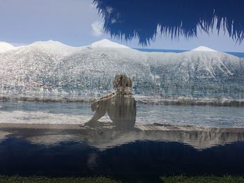 View of frozen lake against mountain range