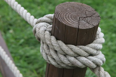 Close-up of rope tied on wooden post