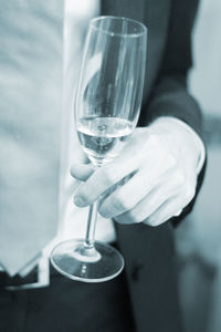Close-up of man holding wine glass