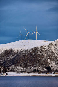 Haramsøya with wind farm turbines on top of its mountain, Ålesund, møre og romsdal, norway.