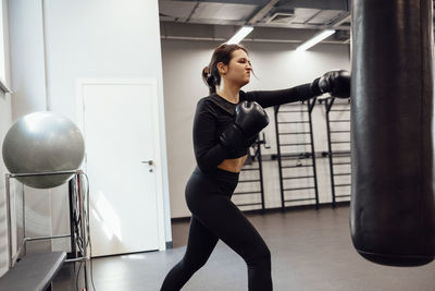 Young woman exercising in gym