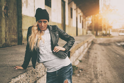 Portrait of fashionable young woman wearing jacket standing outdoors