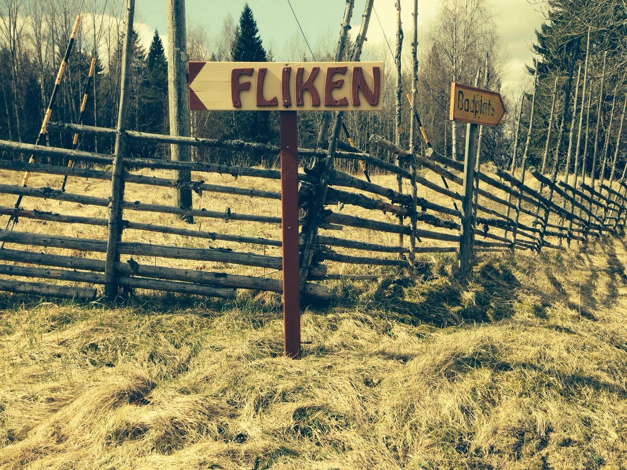 text, communication, western script, information sign, sign, road sign, warning sign, guidance, tree, safety, capital letter, pole, fence, information, empty, outdoors, day, no people, tranquility, sky