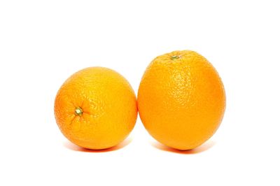 Close-up of orange fruit against white background