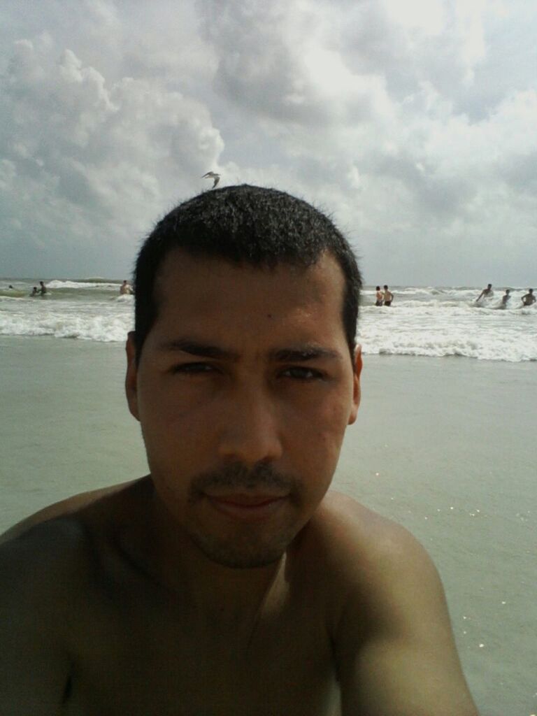 beach, sea, water, shore, lifestyles, sky, portrait, leisure activity, person, young men, looking at camera, sand, headshot, young adult, vacations, front view, horizon over water, sunglasses